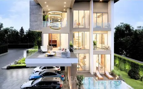 Harmony Hills Villas Pattaya: Modern villa exterior from a different angle, showing the garage and well-lit interiors.