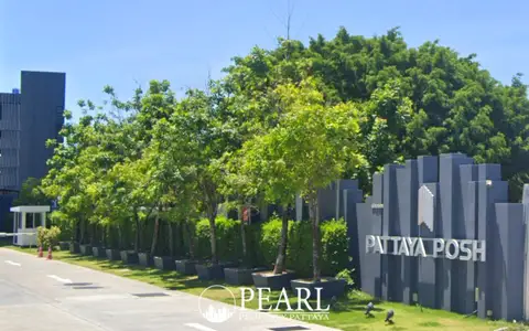 Pattaya Posh fitness center with exercise bikes, treadmills, and panoramic city and sea views.