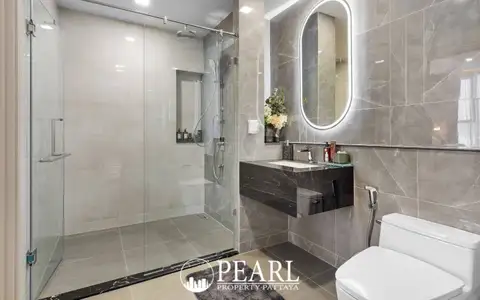 3 Bedroom Condo for Sale at Aquarous Jomtien Pattaya modern bathroom with glass rain shower, marble tiles and LED vanity mirror