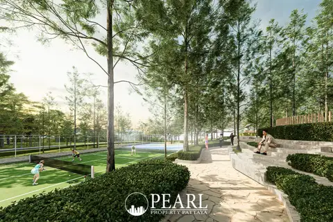 Wisdom First Residences tennis courts and outdoor amphitheater seating surrounded by tall trees.