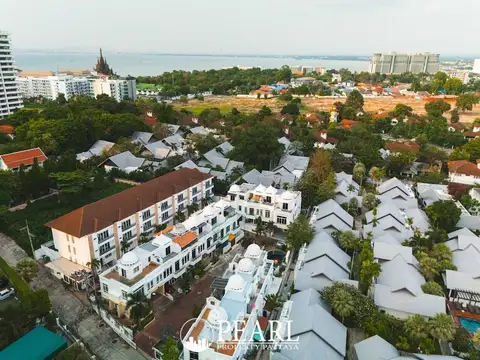 Wongamat Exclusive Place aerial view of multiple white townhouses with domed roofs and surrounding neighborhood.
