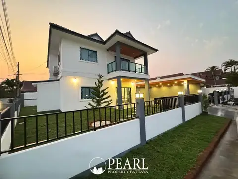 Park Rung Ruang outdoor swimming pool with two lounge chairs and a modern white house under a clear sky.