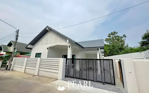 Paradise Hill 2 single-story house with white exterior, grey roof, and black decorative gate.
