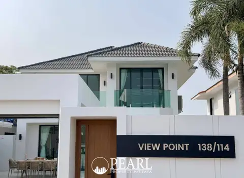 View Point Village modern white house exterior with wooden door and glass balcony.
