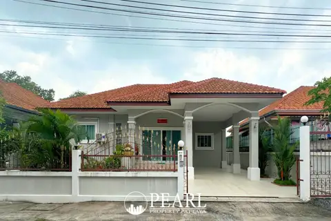 Chaiyaphruek Silver Bell Village front gate and white fence with Thai sign.