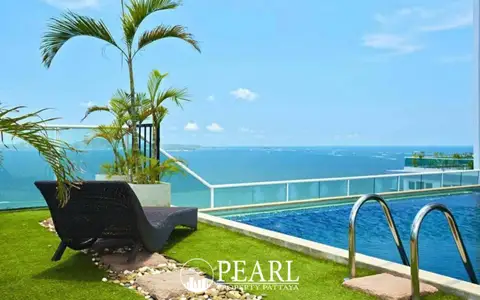 Cosy Beach View rooftop pool with a lounge chair on artificial grass, palm trees, and expansive ocean views