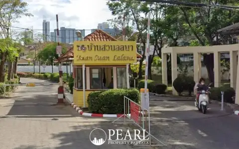 Baan Suan Lalana entrance gate with security booth, signage, and a person on a scooter.