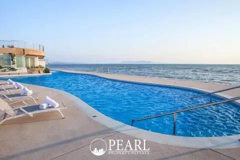 La Royale Beach grand entrance with dual staircases leading to a pool area and illuminated lobby at dusk.