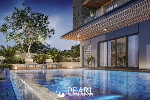 The Arowanyx swimming pool with blue tiled bottom, lounge chairs, and lush landscaping at dusk.