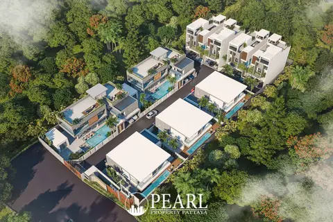 Tree Villa aerial view of multiple modern villas with private pools surrounded by dense green trees.