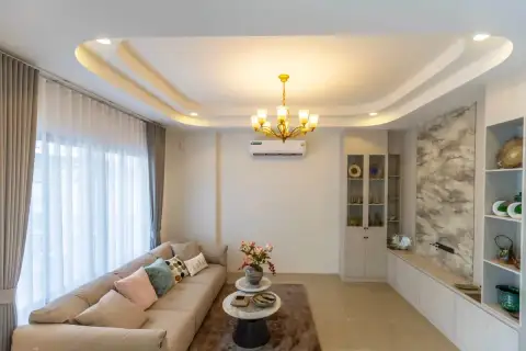 3 Bedroom House for Sale at Phonthep Garden Ville 2 close-up of beige sofa with cushions and marble-top coffee tables on rug