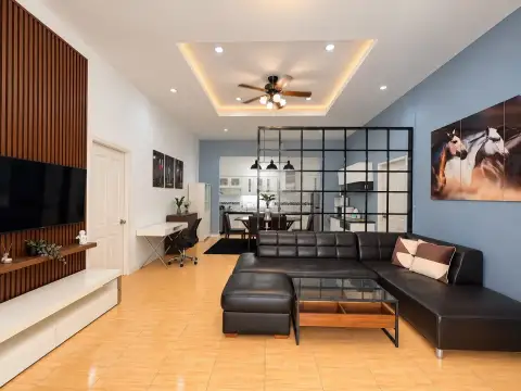 3 Bedroom House for Rent in Pratumnak Hill open-plan living room with ceiling fan, artwork and kitchen view