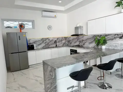 6 Bedroom House for Sale & Rent in Pratumnak Hill modern kitchen with marble countertop and bar stools