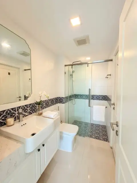 1 Bedroom Condo for Sale at The Orient Resort & Spa bathroom with glass shower and patterned tile accents