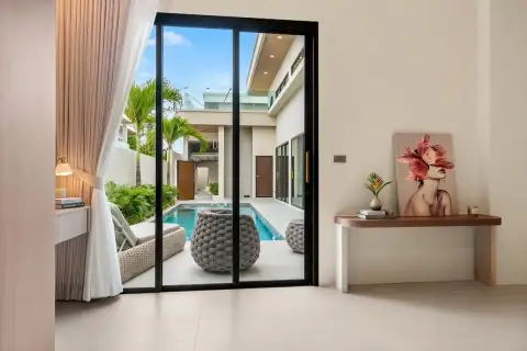 3 Bedroom House for Sale at Perla Villa bedroom view through sliding glass doors to pool and courtyard