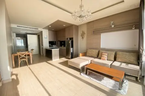 2 Bedroom Condo for Rent at Cetus Beachfront spacious open-plan living and dining area with crystal chandelier, sofa, and modern kitchen