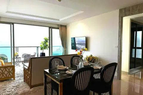 2 Bedroom Condo for Rent at Riviera Monaco dining area with sea view balcony and wall-mounted TV