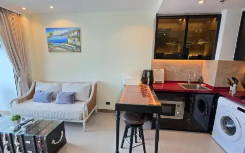 1 Bedroom Condo for Rent at Riviera Ocean Drive kitchenette with red countertop, sink, and microwave