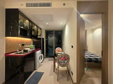 1 Bedroom Condo for Rent at Riviera Ocean Drive view of kitchen and bedroom entrance from hallway