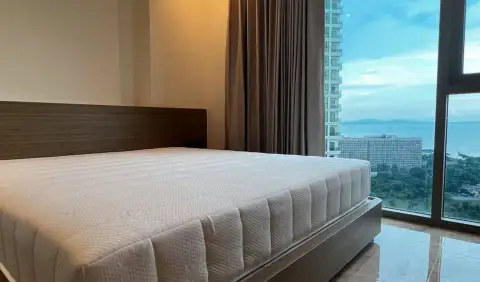 1 Bedroom Condo for Sale at Riviera Ocean Drive bedroom with king bed and floor-to-ceiling sea view window