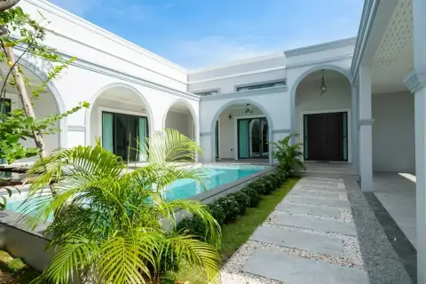 4 Bedroom House for Sale in Nong Prue courtyard pool with tropical palms and arched entrance to main door