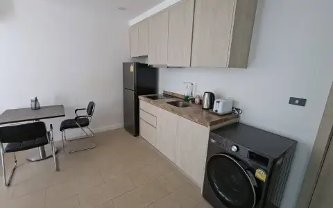 2 Bedroom Condo for Sale at Sea Zen kitchenette with fridge, washing machine and dining table