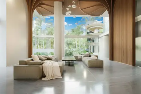 Secret Garden Condominium lobby with a reception desk, stylish seating, and wood-paneled walls and ceiling.