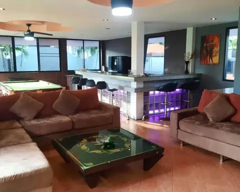 2 Bedroom House for Rent in Mabprachan game room with pool table, red sofas, and wall-mounted TV