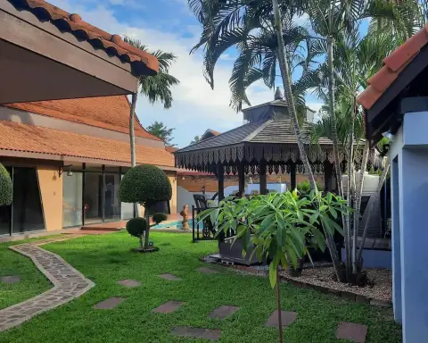 2 Bedroom House for Rent in Mabprachan garden pathway with palm trees and wooden gazebo near the pool
