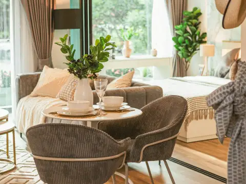 2 Bedroom Condo for Sale at Siam Oriental Oasis dining table with place settings beside sofa and bed near window