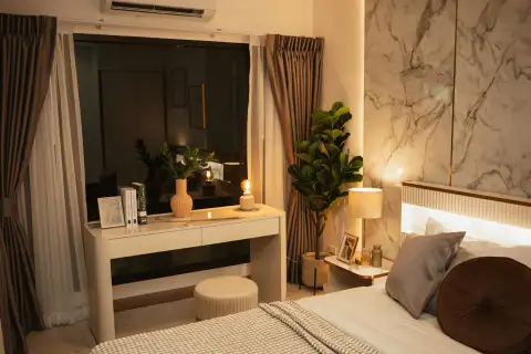 2 Bedroom Condo for Sale at Siam Oriental Oasis bedside vanity desk with mirror, lamp and potted plant at night