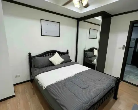 2 Bedroom Condo for Rent at Siam Oriental Twins bedroom with black bed frame, mirrored wardrobe, and wall art