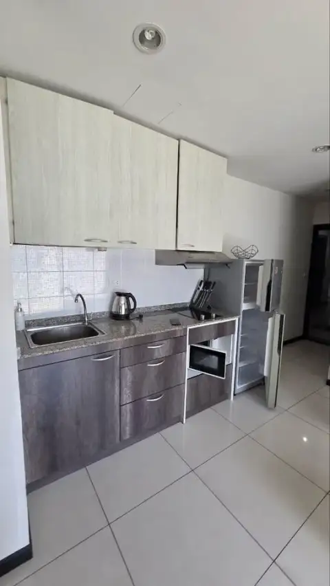 1 Bedroom Condo for Sale at Siam Oriental Tropical Garden kitchen with granite countertop and fridge