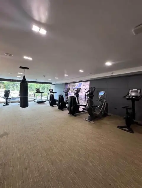 1 Bedroom Condo for Sale at Sky Residences Pattaya fitness center with treadmills and punching bag