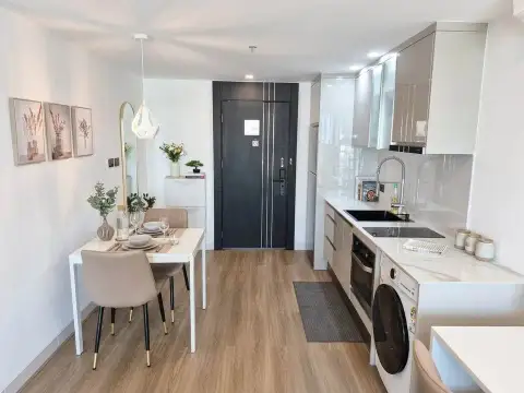 1 Bedroom Condo for Sale at Sky Residences Pattaya dining area and galley kitchen with wood flooring