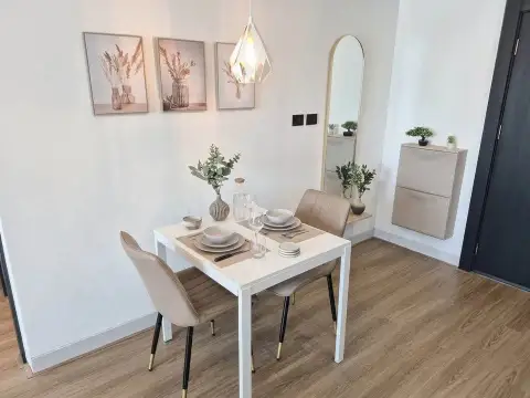 1 Bedroom Condo for Sale at Sky Residences Pattaya dining table set for two near entrance mirror