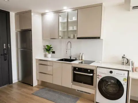 1 Bedroom Condo for Sale at Sky Residences Pattaya modern kitchen with built-in oven and washing machine