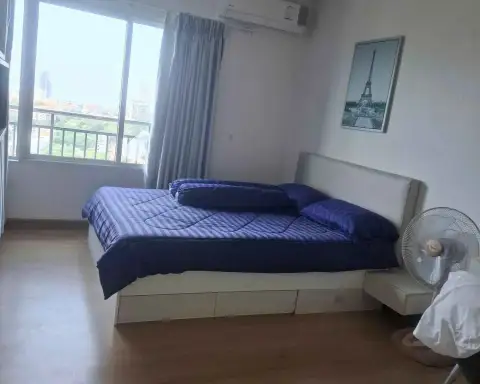 1 Bedroom Condo for Sale at Supalai Mare Pattaya bedroom with double bed, city view window and Eiffel Tower artwork