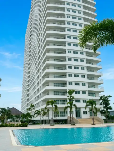 View Talay 8 condo tower exterior with curved balconies overlooking the swimming pool