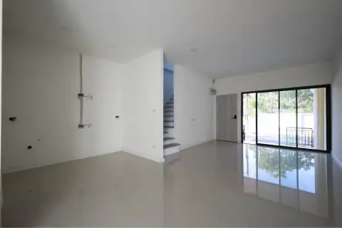 4 Bedroom Townhouse for Sale in Takhian Tia open living area with glossy tile floor, staircase, and sliding glass door to patio
