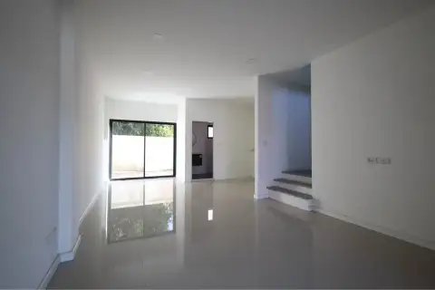 4 Bedroom Townhouse for Sale in Takhian Tia spacious living room with tiled floor, staircase, and sliding door to outside wall
