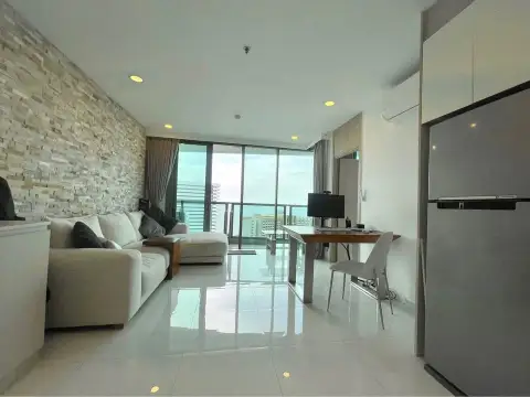 1 Bedroom Condo for Sale at The Cloud living room with sofa, work desk, and floor-to-ceiling balcony windows