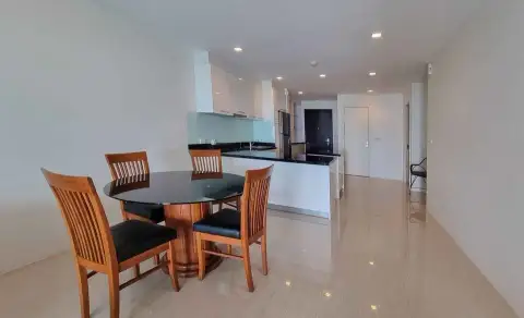 2 Bedroom Condo for Sale at The Elegance dining area with wooden table and open-plan kitchen view