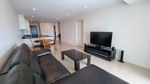 2 Bedroom Condo for Sale at The Elegance living room with black leather sofas and flat-screen TV