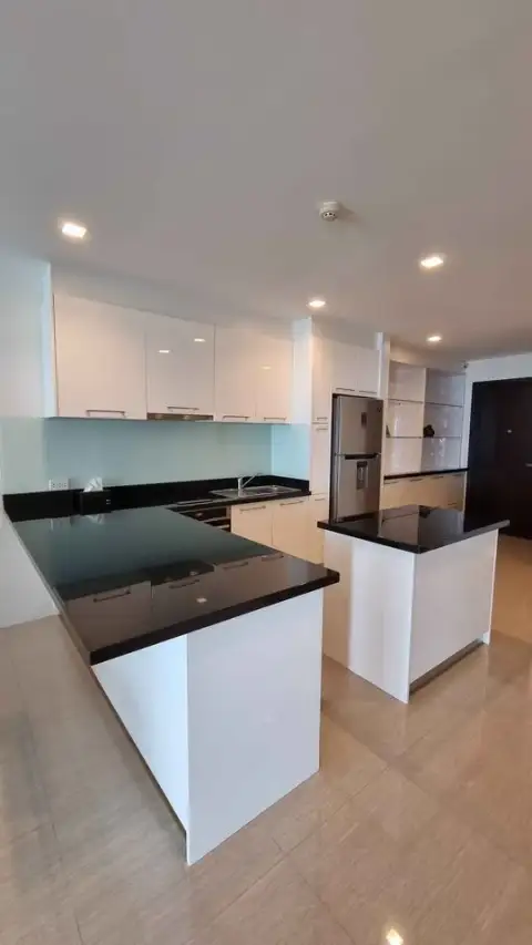 2 Bedroom Condo for Sale at The Elegance modern kitchen with white cabinets and black granite countertops