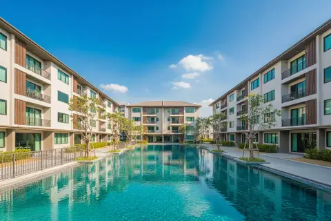 The Empire Tower Pattaya, a studio apartment showing the bed, a small dining table, and a compact kitchen area.