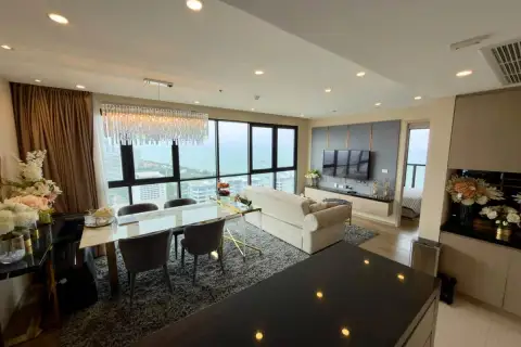 2 Bedroom Condo for Sale at The Panora Pattaya open-plan living and dining area with sea view and crystal chandelier