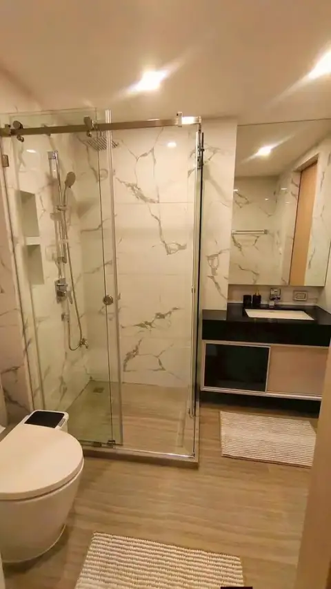 1 Bedroom Condo for Rent at The Panora Pattaya marble bathroom with glass-enclosed walk-in shower