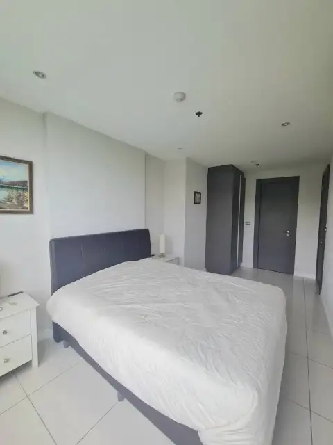 1 Bedroom Condo for Sale at The Point Pratumnak spacious bedroom with wardrobe and tiled flooring
