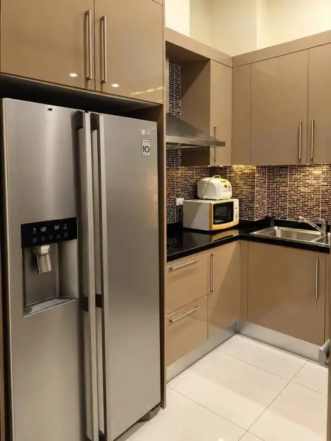 1 Bedroom Condo for Sale at The Residence Jomtien kitchen with stainless steel refrigerator and mosaic backsplash